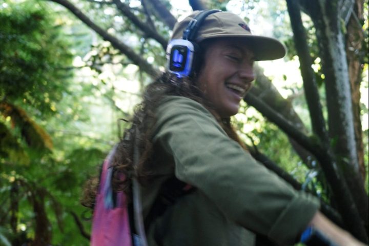 a person standing next to a tree