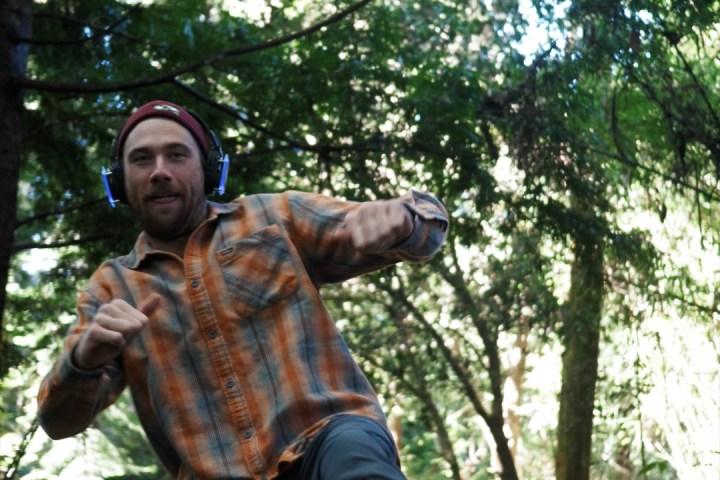 a man standing next to a tree