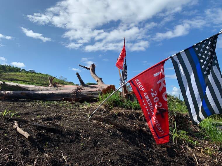 a flag on top of a grass covered field