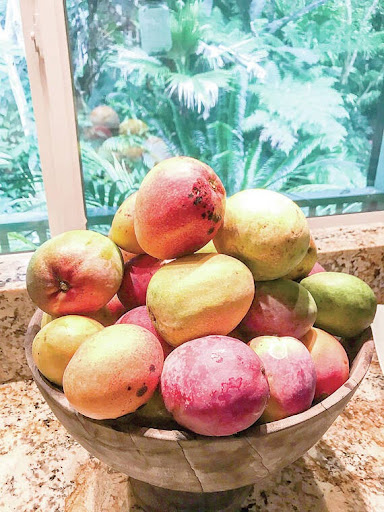 a bowl of fruit sitting on a table