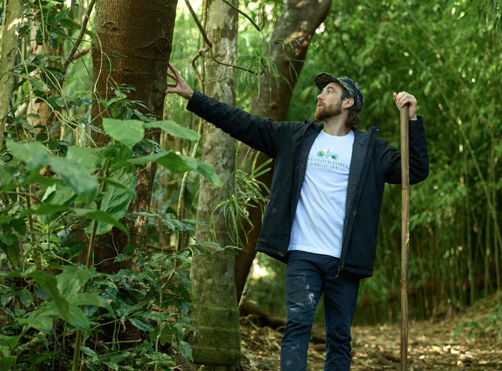 a man standing next to a tree