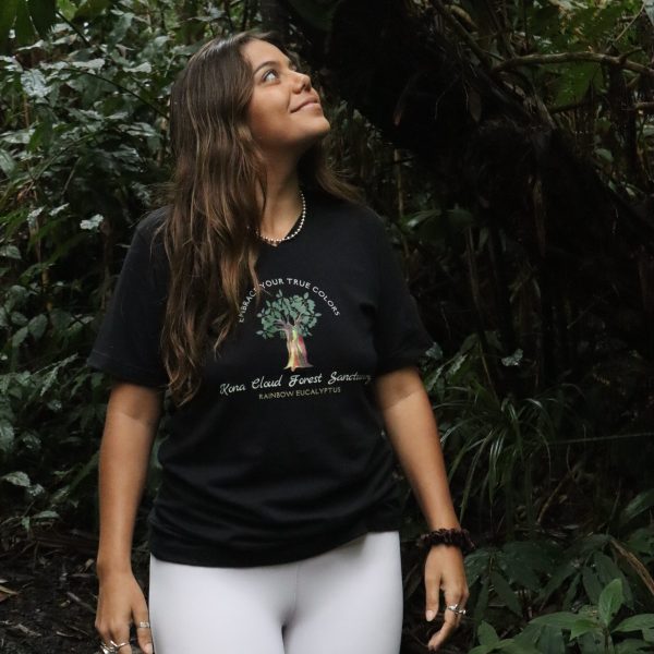 a person standing next to a forest