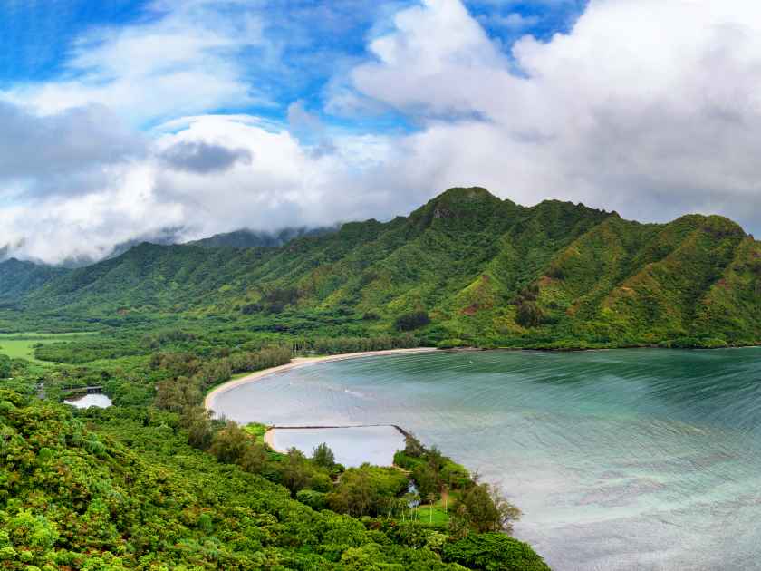 a body of water with a mountain in the background