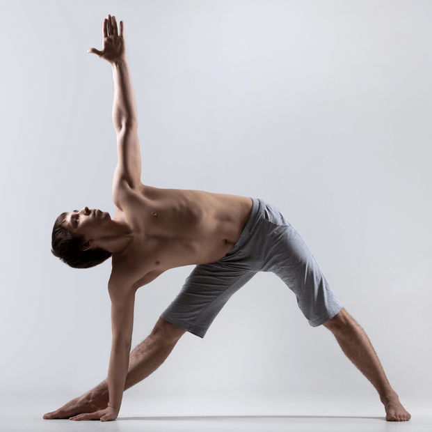 Man performing yoga in a wide-legged position with one arm raised.
