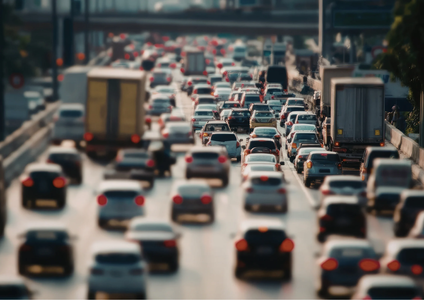 Heavy traffic on a multi-lane highway with cars and trucks.